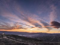 Rural California: An Open Road amidst Grass and Mountains