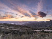 Rural California: An Open Road amidst Grass and Mountains