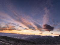 Rural California: An Open Road amidst Grass and Mountains