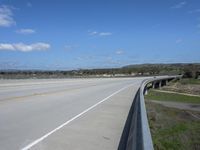 the interstate and a highway is in view from a truck driving over the bridge across it