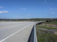 the interstate and a highway is in view from a truck driving over the bridge across it