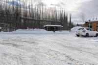 a car is parked at a rural parking lot on a snowy day and it has fallen over