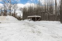 snow piled to the ground outside of an empty building on a winter day or in winter time