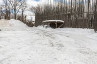 snow piled to the ground outside of an empty building on a winter day or in winter time