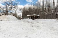 snow piled to the ground outside of an empty building on a winter day or in winter time