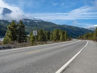 Rural Colorado Landscape: Majestic Mountains and Snowy Roads