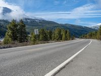 Rural Colorado Landscape: Majestic Mountains and Snowy Roads