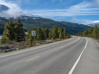 Rural Colorado Landscape: Majestic Mountains and Snowy Roads