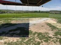 a couple of mirrors that are sitting on the ground in grass and dirt area of a house