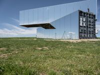 an upside down reflection shows the inside of it's enclosure and in the grass