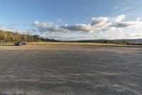 an empty parking lot is pictured in this photo from inside the picture, there is a car that's parked by