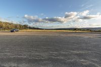 an empty parking lot is pictured in this photo from inside the picture, there is a car that's parked by