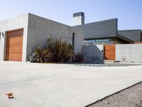 a gray concrete building with stairs and door at the top of the floor next to it is steps leading down to the doorway