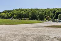 a woman running in a park in the middle of the day, with people on the other side