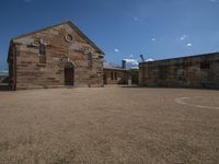 the old stone building is empty on a sunny day from afar - to - see