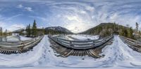 this fisheye is shown on the snow - covered slopes near the water tank at the mountaintop