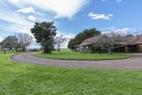 a wide driveway leads to the front yard area of the home, which is situated directly off to the lake