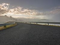 Road Leading to a Lake on the Horizon in a Rural Landscape