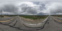 a mirror photograph on a road in the middle of nowhere in a cloudy sky with some clouds