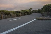 the asphalt is grey and a white line is in between two lines that indicate where to cross