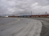 an empty parking lot with tracks and freight train cars on it while there is no one on the tracks