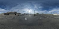 a wide shot of an empty parking lot during the day time, with no cars