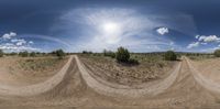 three dirt tracks through the air over desert terrain on a sunny day in the daytime