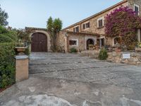 a large old style home with stone steps leading up to it's front entrance