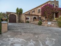 a large old style home with stone steps leading up to it's front entrance