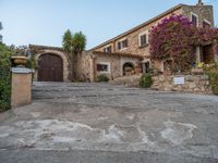 a large old style home with stone steps leading up to it's front entrance