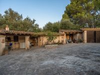 a courtyard with a kitchen and an oven inside of it and a building that has no doors