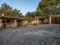 a courtyard with a kitchen and an oven inside of it and a building that has no doors