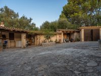 a courtyard with a kitchen and an oven inside of it and a building that has no doors