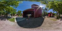 a mirror view of a barn in the woods of california, usa, viewed on a fish - eye lens lens