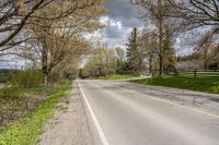 a scenic rural road and farm area during the day in springtime, minnesota, usa