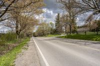 a scenic rural road and farm area during the day in springtime, minnesota, usa