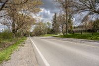 a scenic rural road and farm area during the day in springtime, minnesota, usa