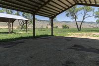 an open covered area with a view of the mountain range in the distance outside of the building