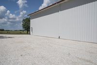 the garage has white wall and gravel around it for an additional purpose, or in any style