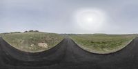 a 360 view of the street from an angled perspective of the road with a car driving on the side and a mountain to the top