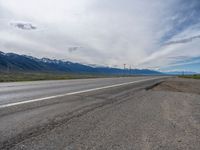 Rural Road in Colorado: A Cloud-Filled Sky Above