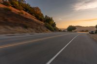 Rural Road at Dawn with Sunlight Breaking through the Clouds