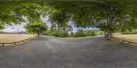 the view of a empty road from a car in the road through a gate is visible on a wide angle