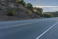 the car is driving along the freeway on a sunny day in the countryside with trees