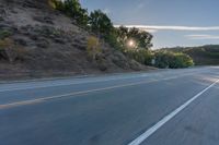 the car is driving along the freeway on a sunny day in the countryside with trees