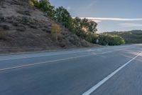 the car is driving along the freeway on a sunny day in the countryside with trees