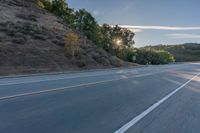 the car is driving along the freeway on a sunny day in the countryside with trees