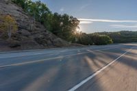 the car is driving along the freeway on a sunny day in the countryside with trees