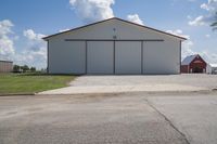 there is a large white building and barn in the background that's a lot to see