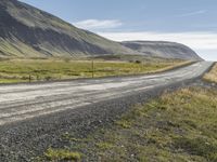 Rural Road in Iceland: Surrounded by Vegetation and Grass on a Slope